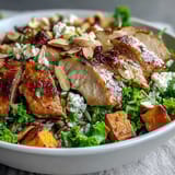 Colorful Harvest Bowl featuring wild rice, kale, sweet potatoes, apples, almonds, and goat cheese ready to serve.