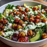 Colorful Lemon Vinaigrette Grain Bowl with Roasted Chickpeas, Cherry Tomatoes, and Avocado Slices
