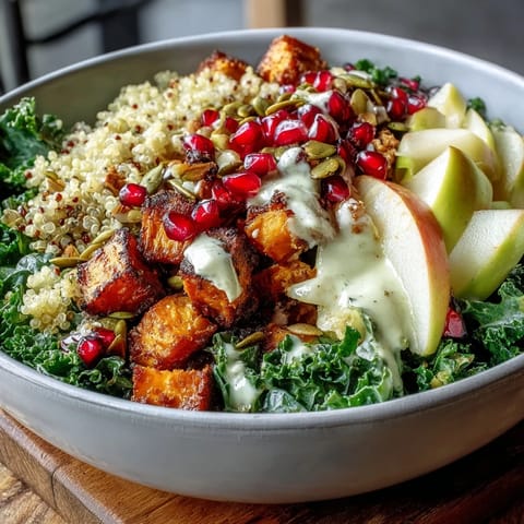 Kale Harvest Grain Bowl served in a rustic bowl, loaded with quinoa, roasted sweet potatoes, and massaged kale.