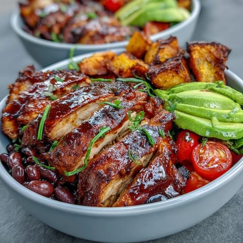 Juicy grilled BBQ chicken meal prep bowls with vibrant sweet potato and veggies.