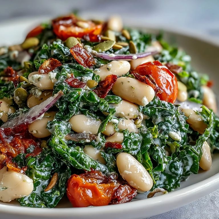 Hearty Mediterranean kale salad with white beans, red onions, and sunflower seeds, ready as a quick vegetarian lunch or side.