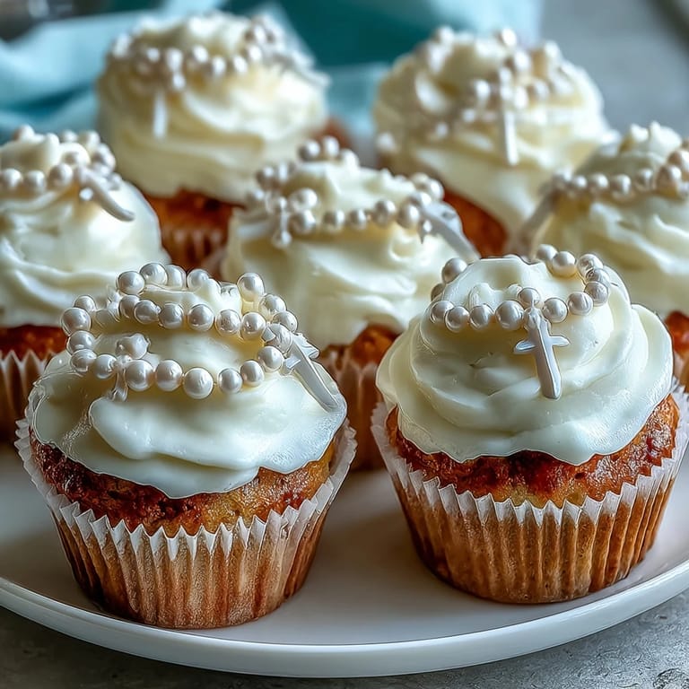 Celebrate First Communion with these charming mini cupcakes, each adorned with a handcrafted fondant rosary, offering a sweet and meaningful dessert for your gathering.